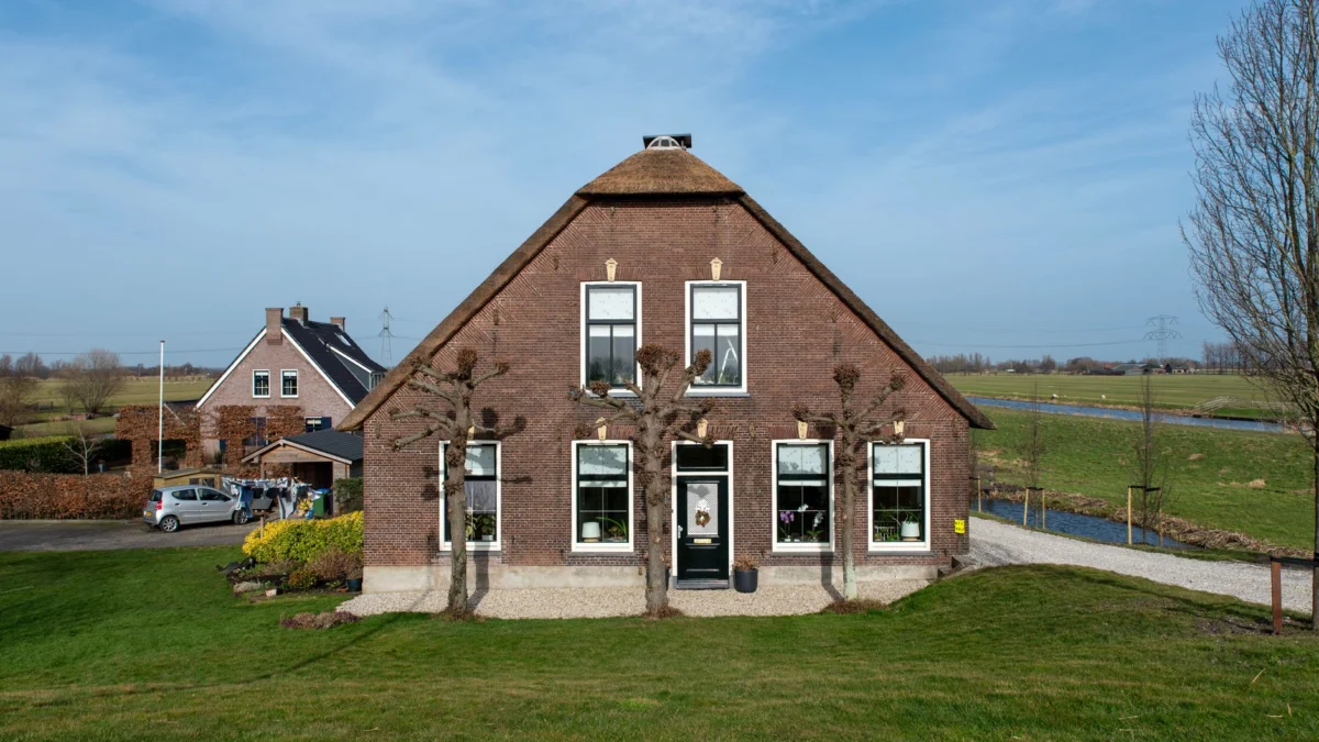Charmante Hollandse boerderij met rieten dak in een schilderachtige landelijke omgeving.